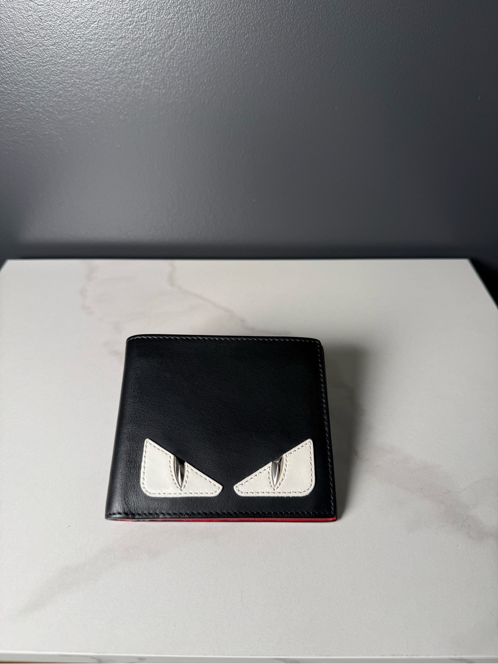 Fendi Black Leather Men’s Wallet with White Eye Accents and Red Edge